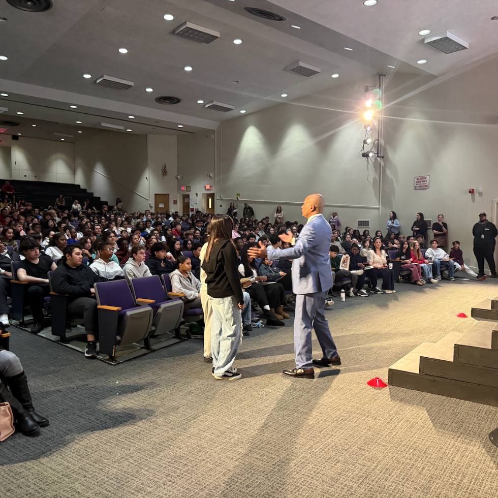 man standing in front of audience in auditorium