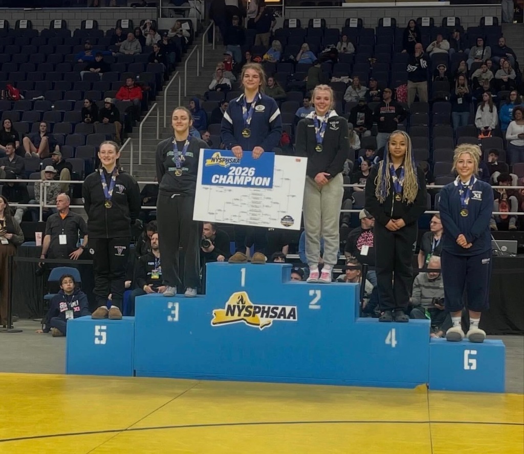 Wrestlers on award podium 