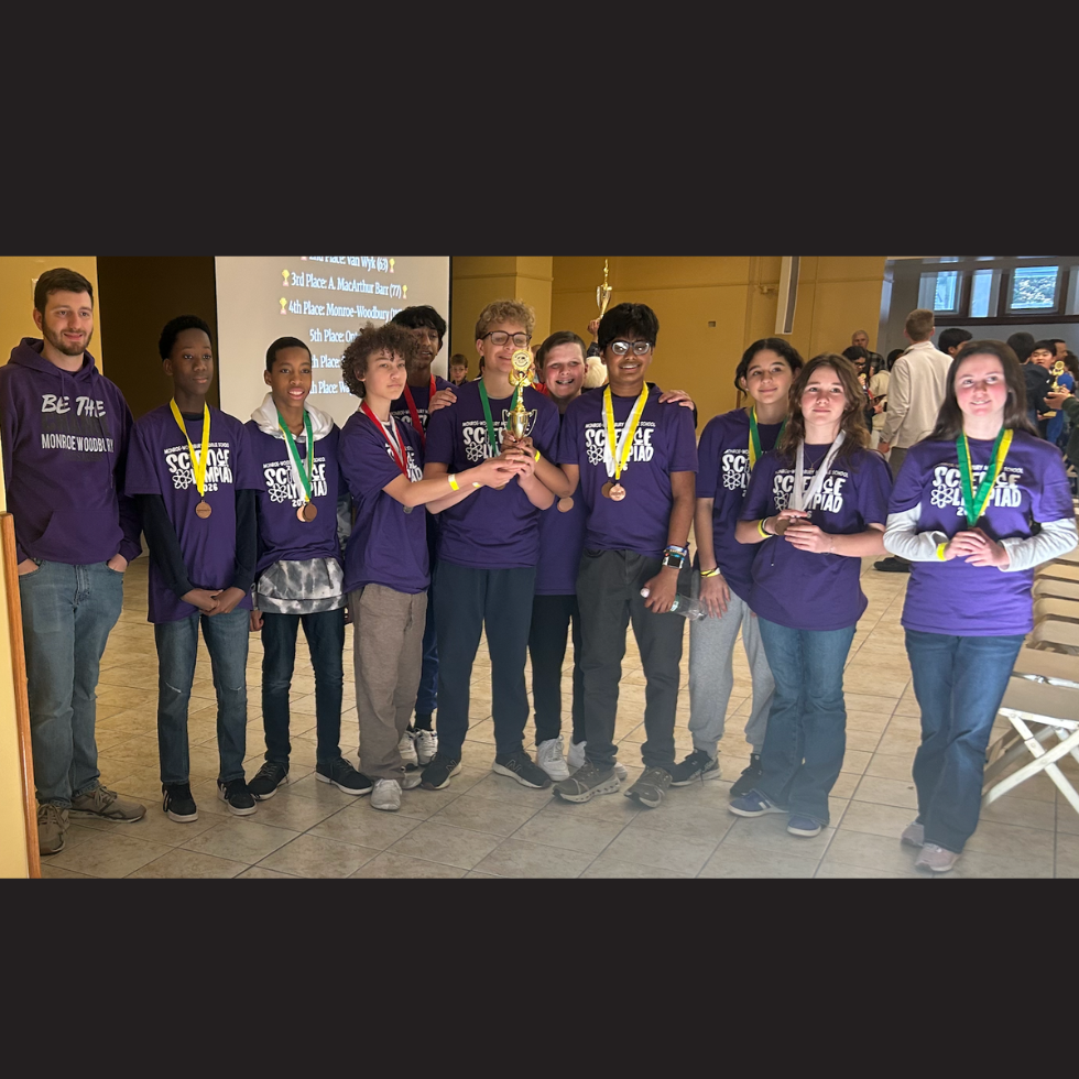 students standing holding a trophy