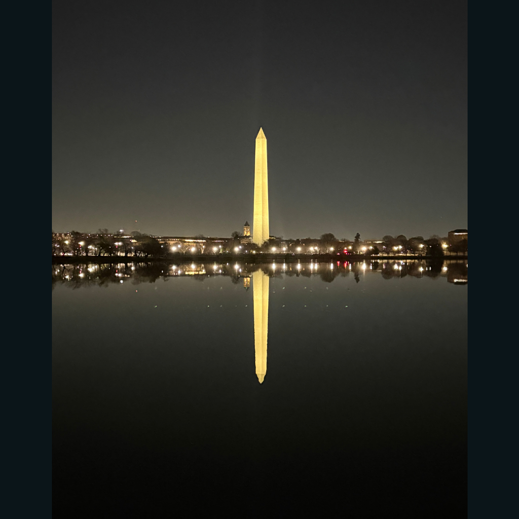 The Washington Monument reflection in the water at night.