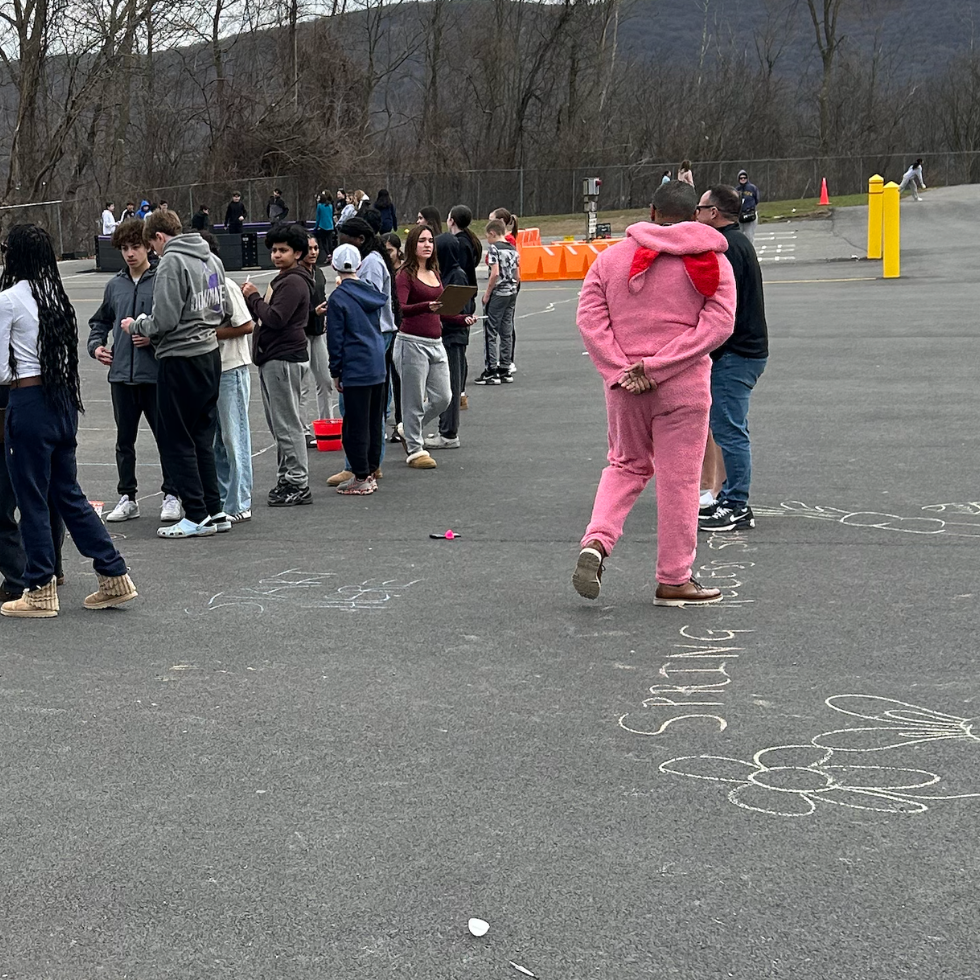 students standing outside, person wearing a bunny outfit