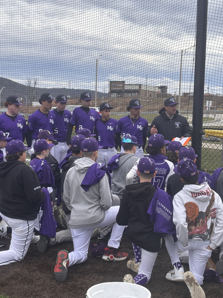 baseball players kneeling
