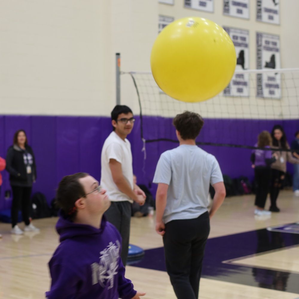 student hitting ball 