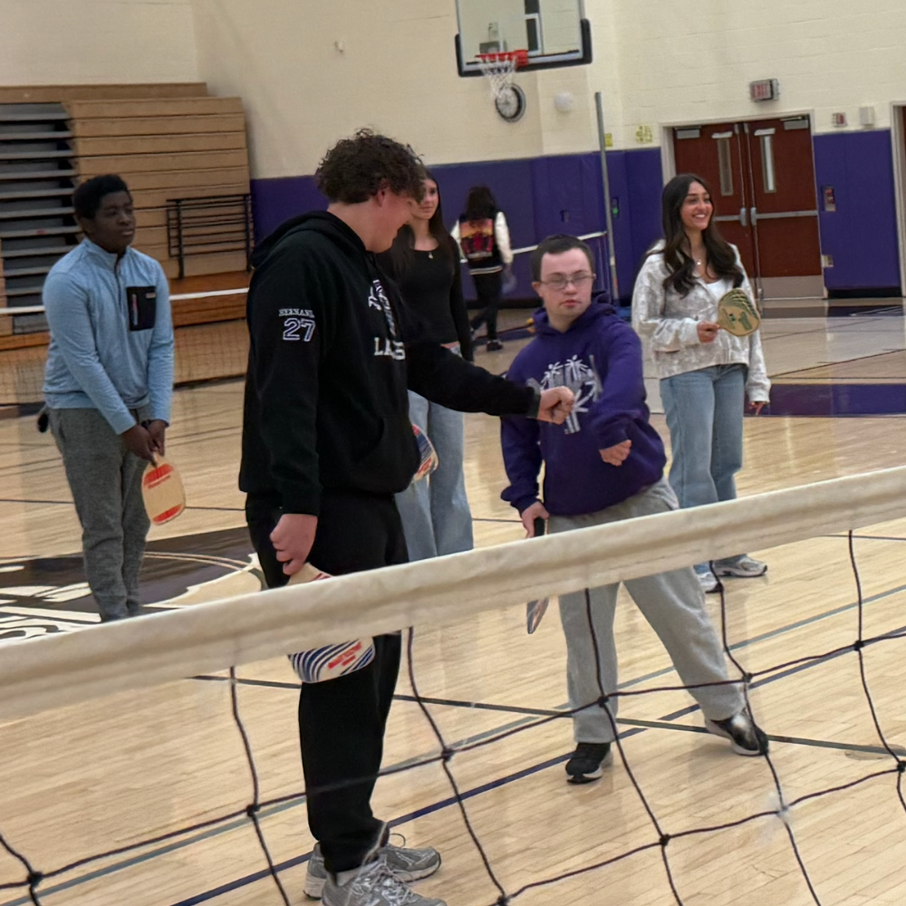 students holding fists together 