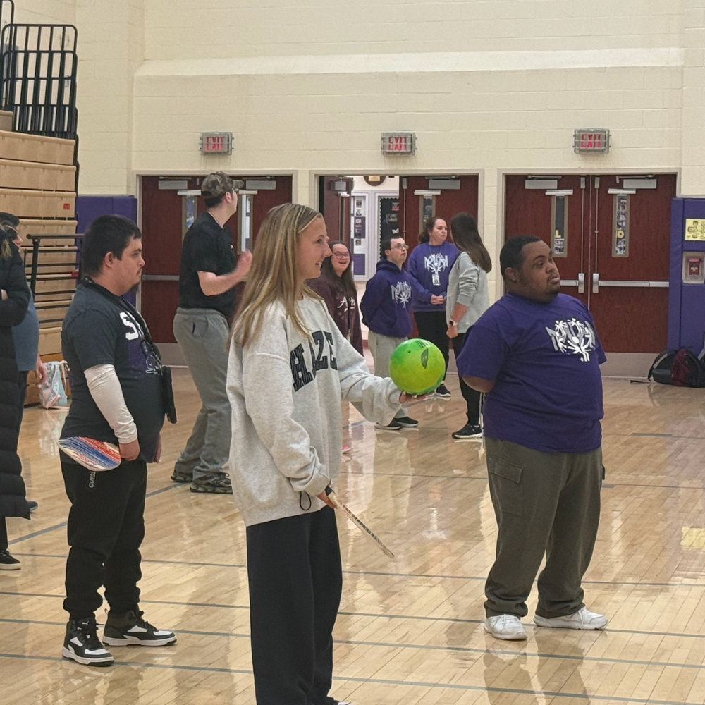 student holding a ball 