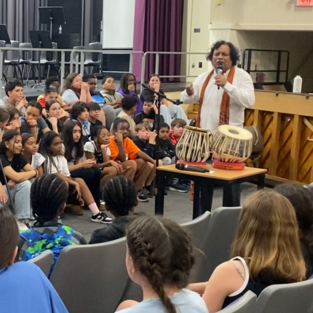 man with two drums and microphone