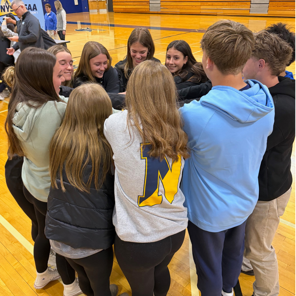 students gather in circle to celebrate and cheer