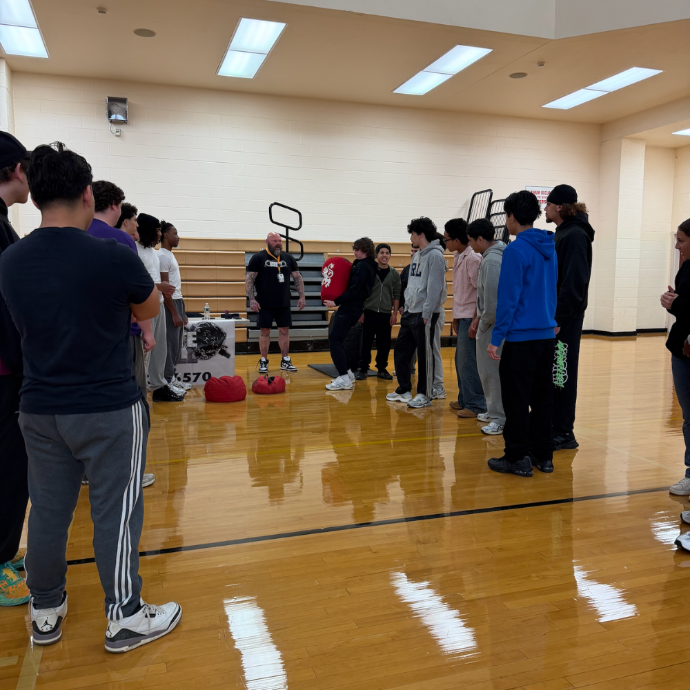 students lined up in a gym 