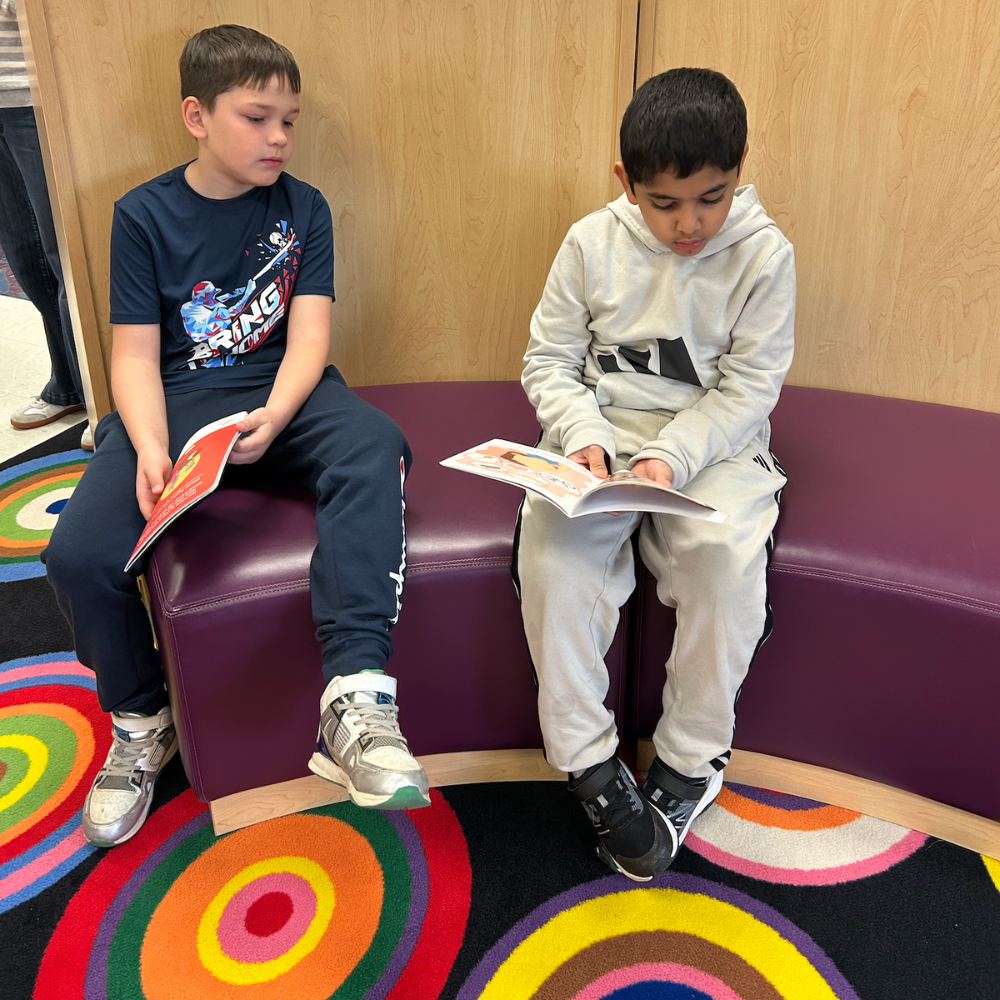 two students reading a book