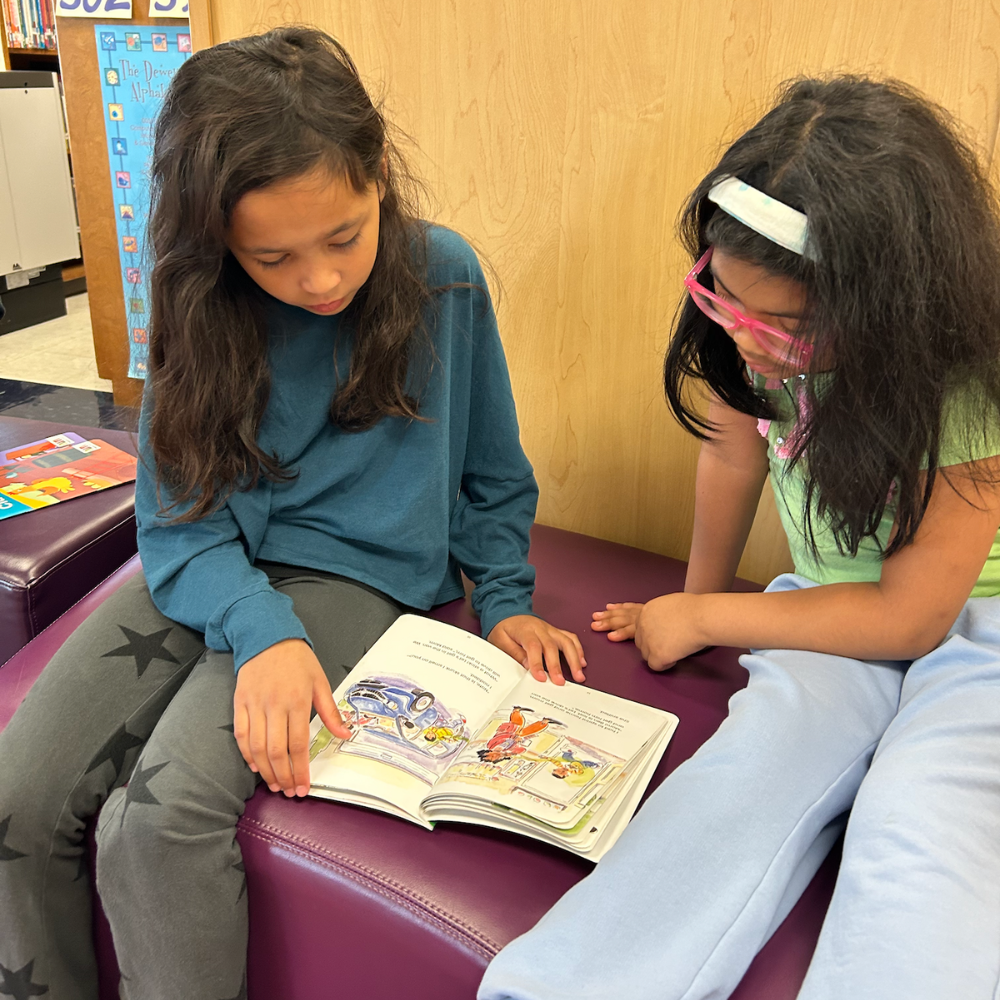 two students reading a book