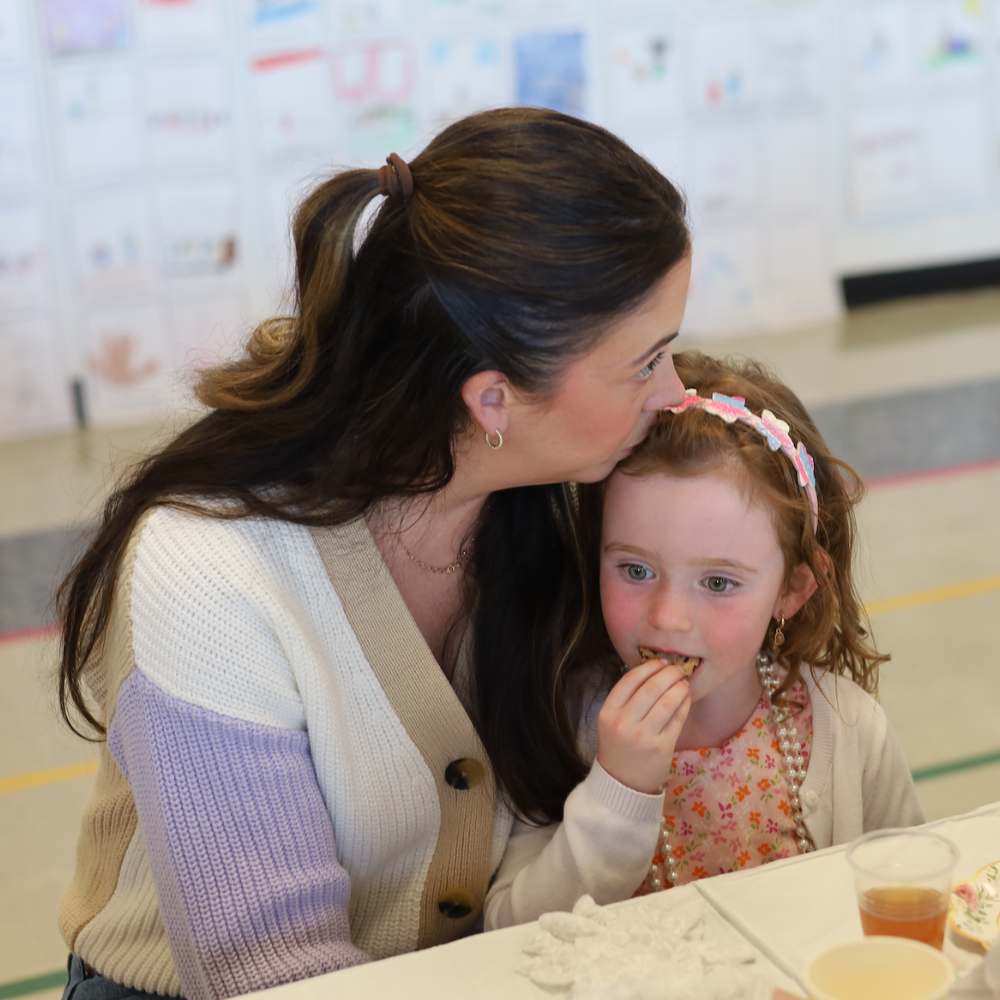 woman with a child eating a cookie 