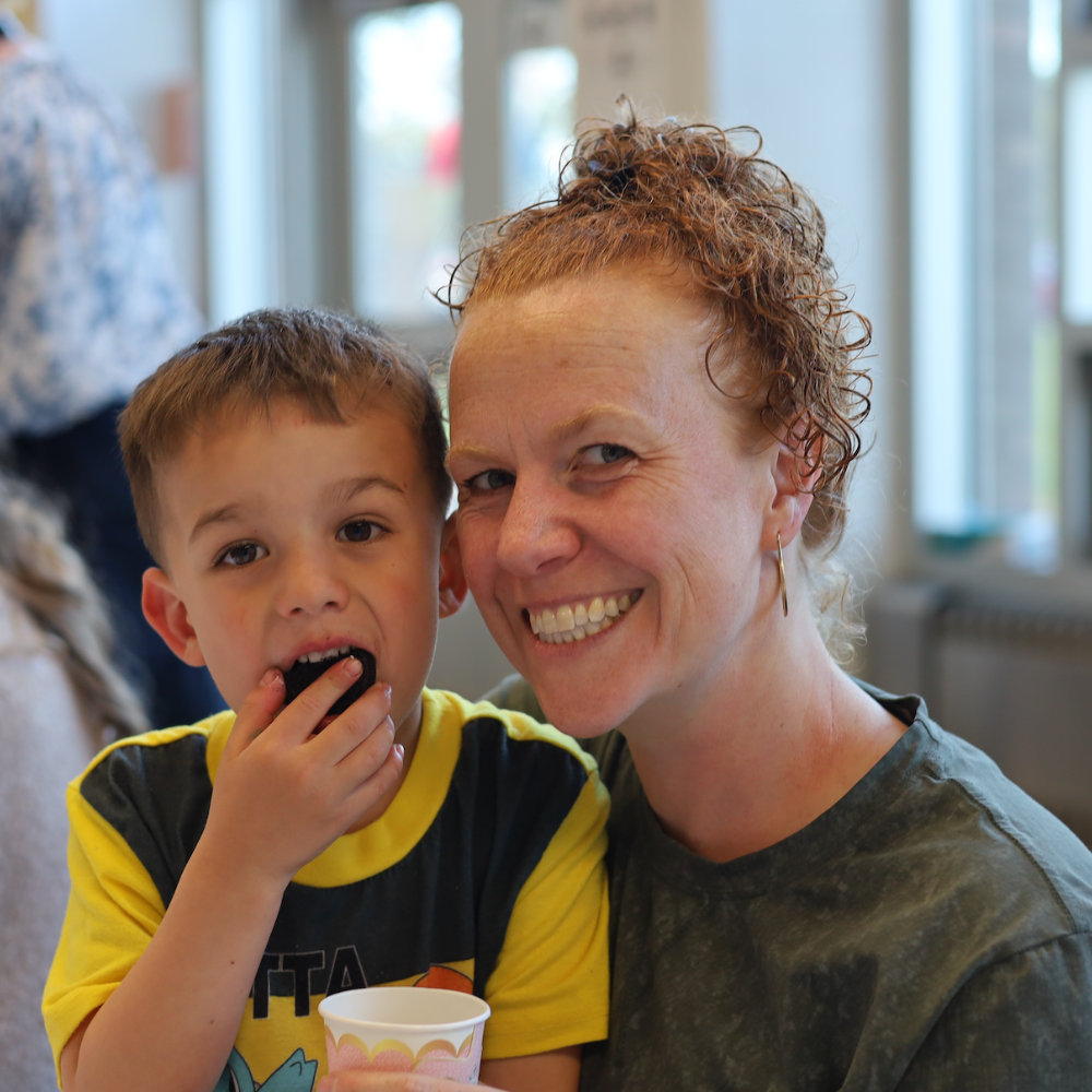 woman with a child eating a cookie 