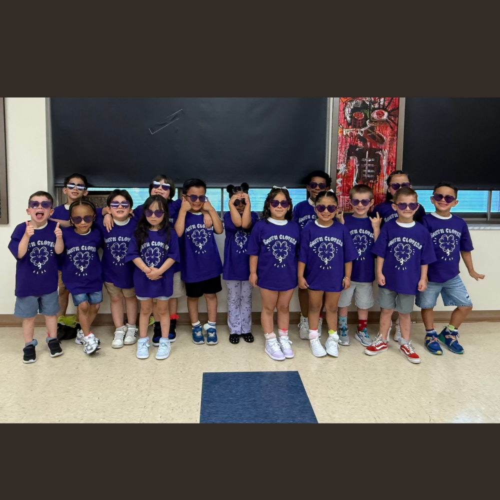 students smiling wearing heart glasses 