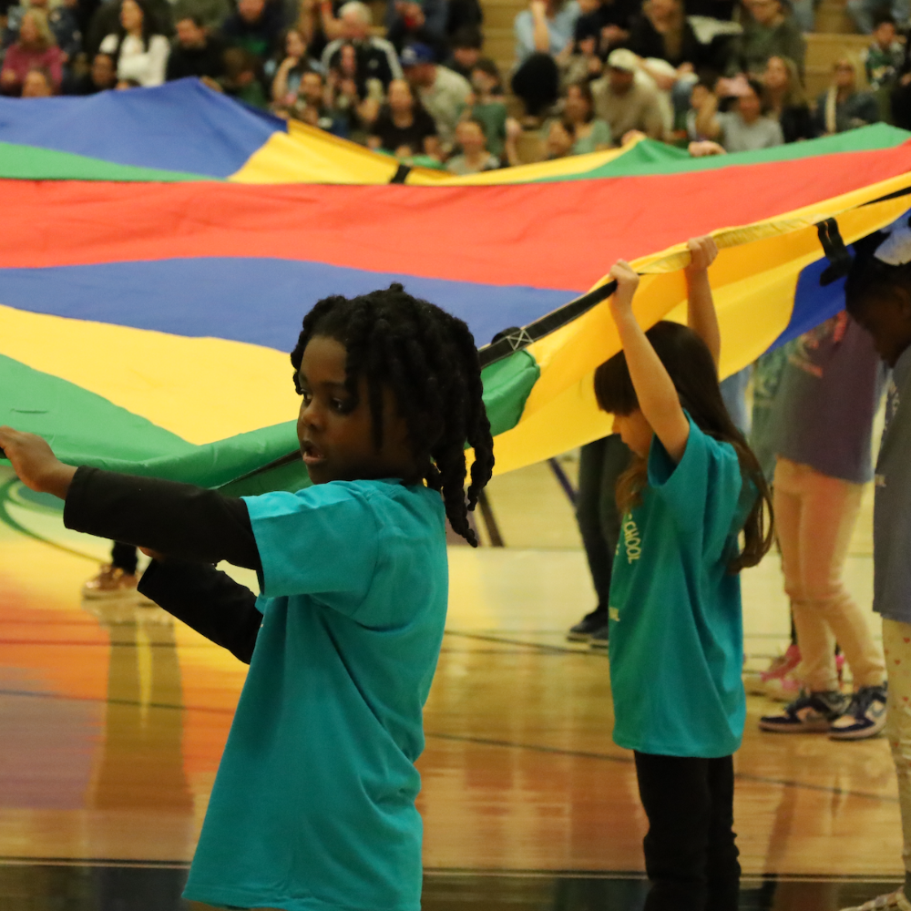 student holding colorful flag