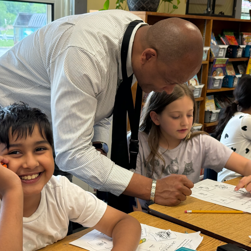 student smiling and man helping student