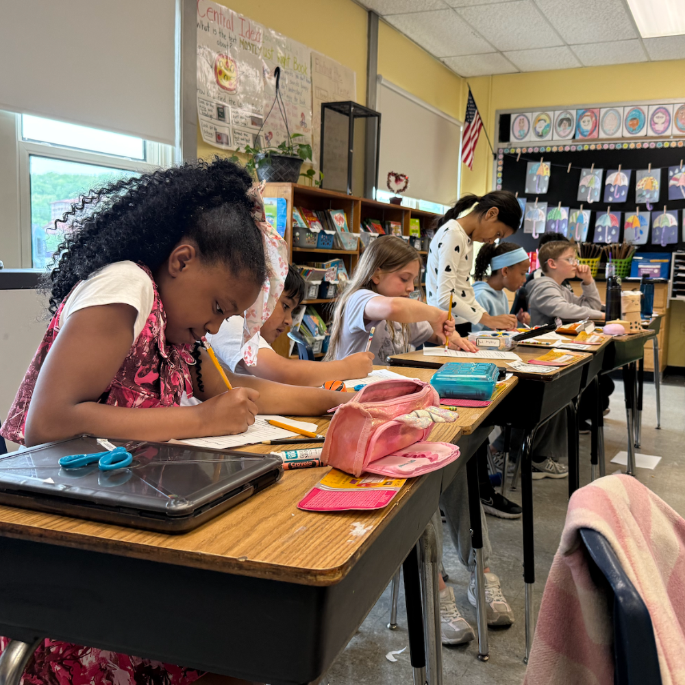 students writing on brown table