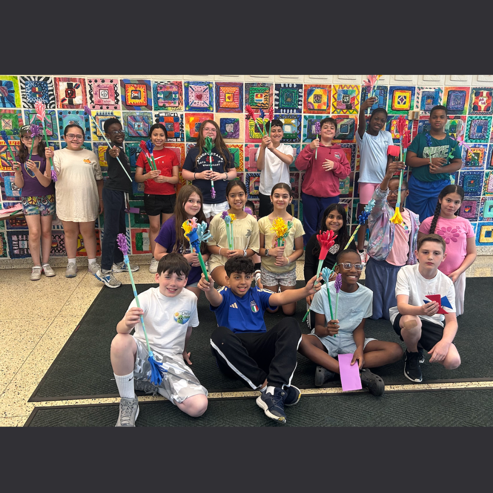 students holding paper flowers 
