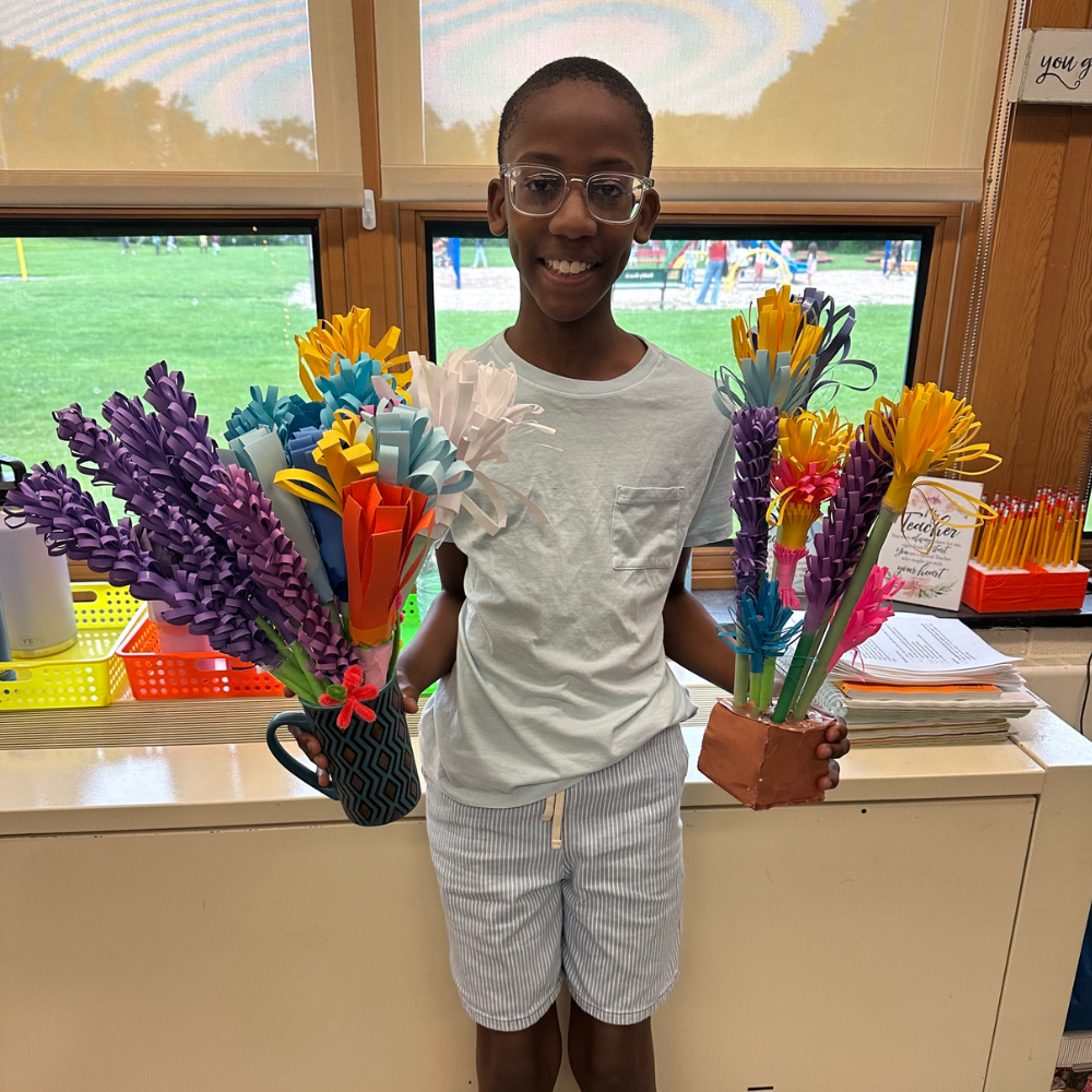 student holding colorful bouquet of flowers