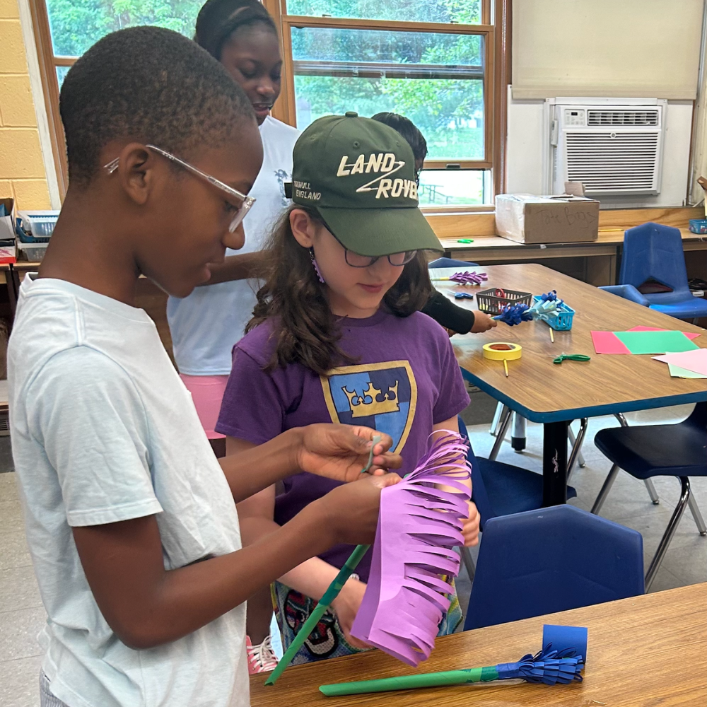 students cutting paper flowers