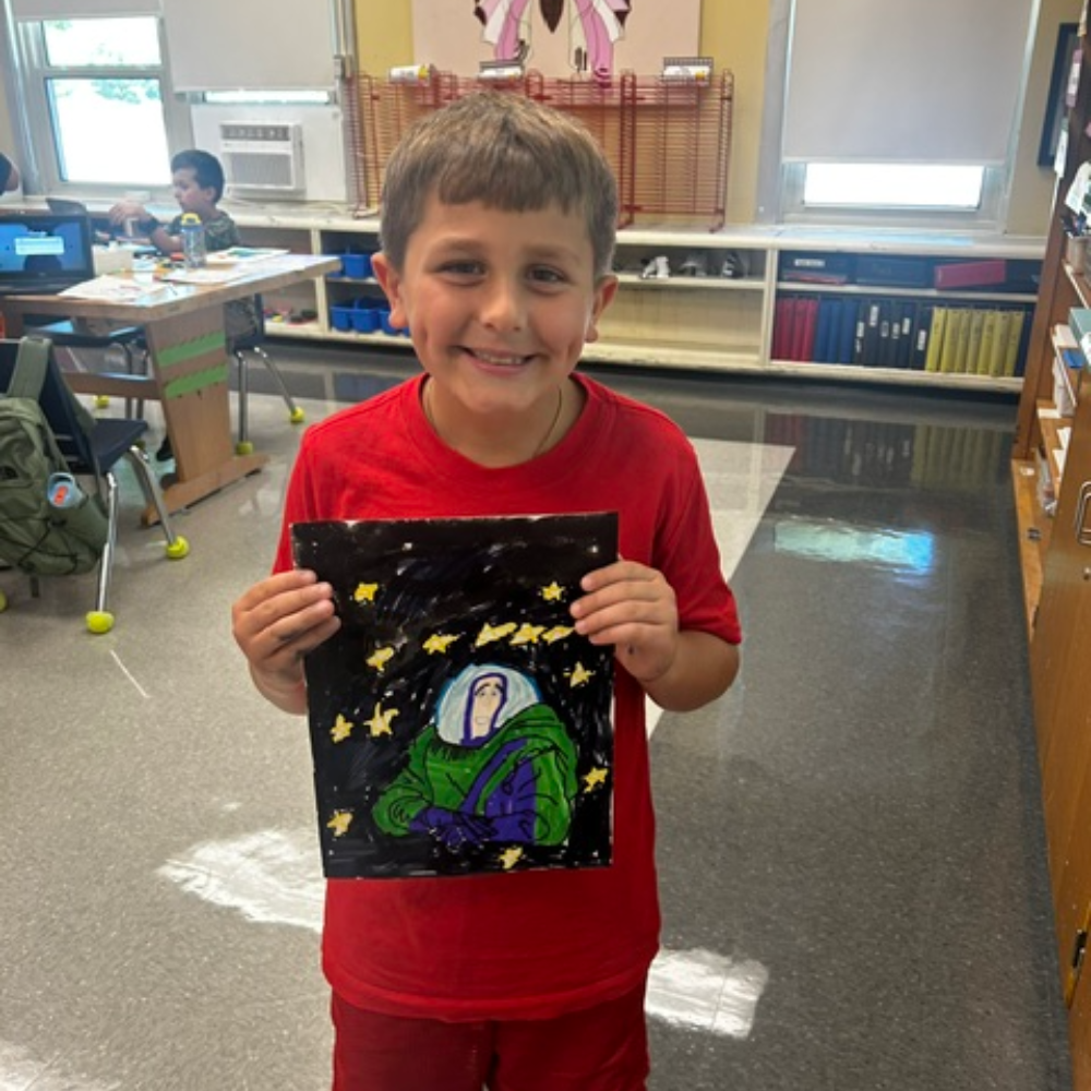 student with red shirt holding painting