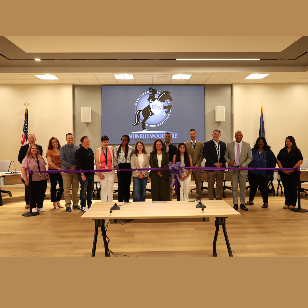 men and women holding a purple ribbon