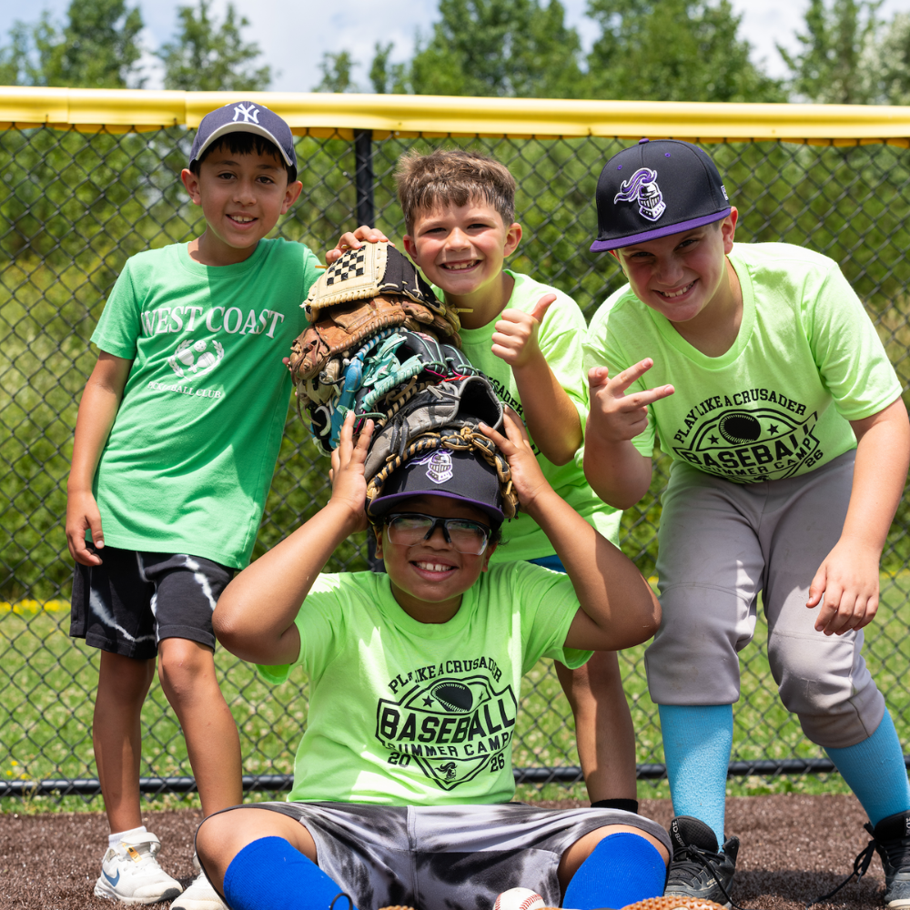 four students wearing baseball caps and gloves 