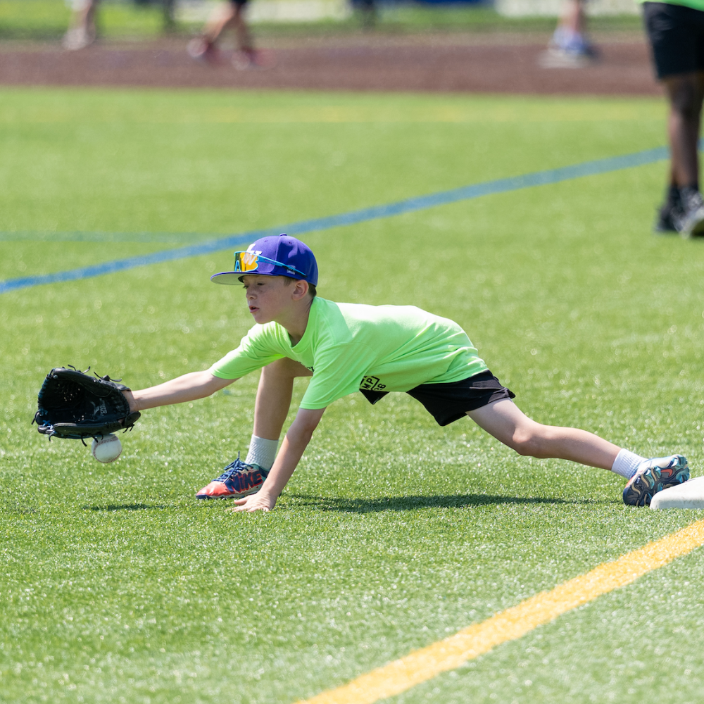 one student catching a baseball 