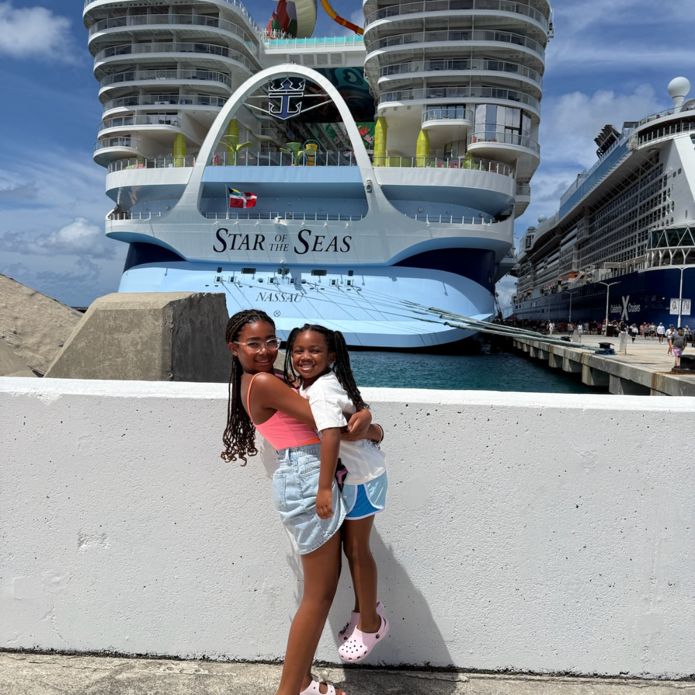 two girls standing in front of a cruise ship, Star of the Seas