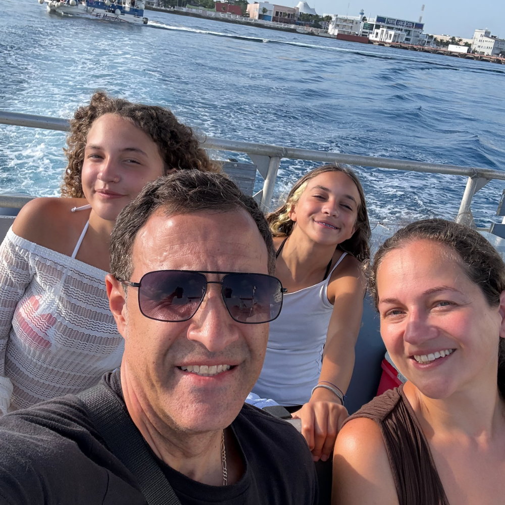 four people sitting on boat