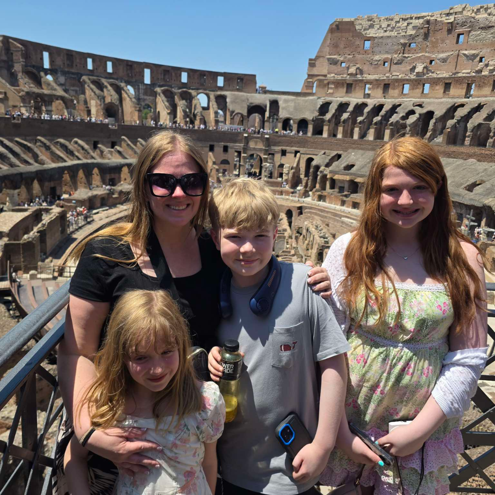 four people standing in a stadium