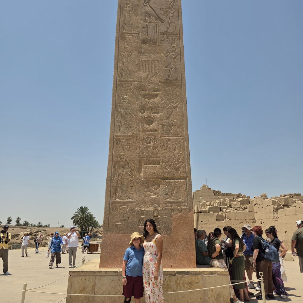 two people standing in front of a statue