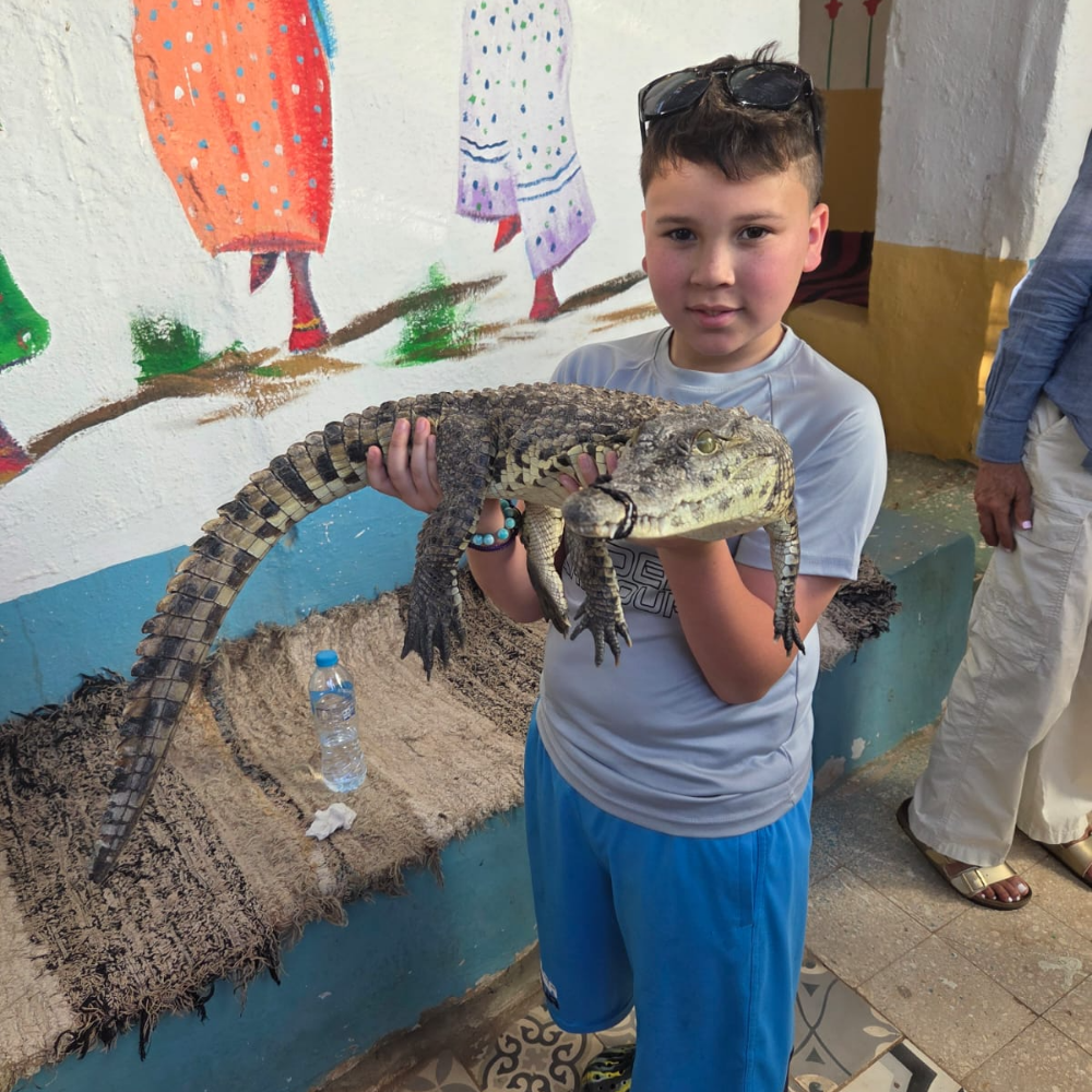 student holding an alligator