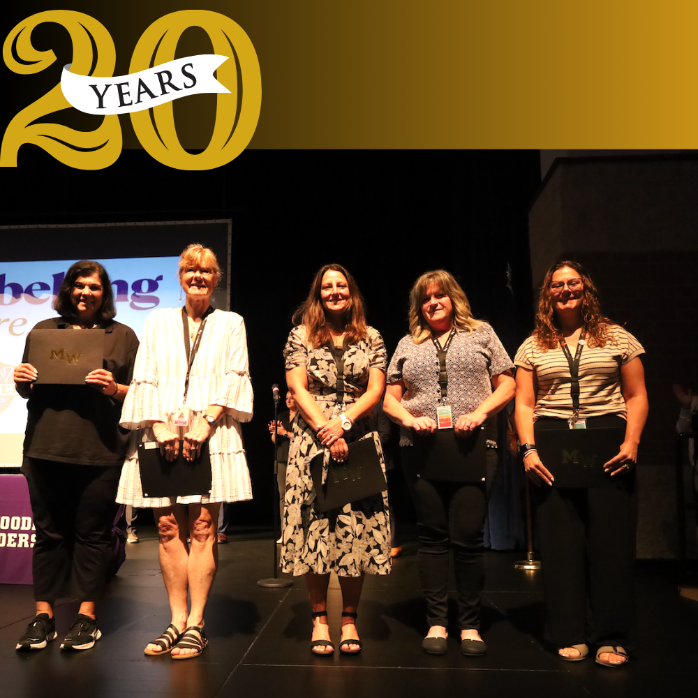 photo of 5 people standing on stage 20 years