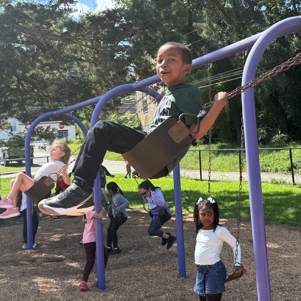 student swinging on a swing