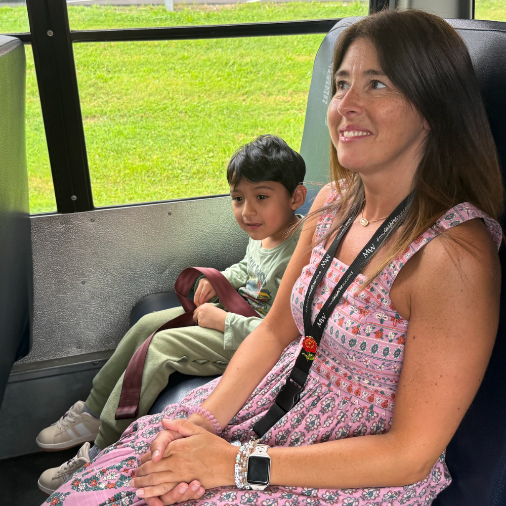 teacher and student sitting on a bus