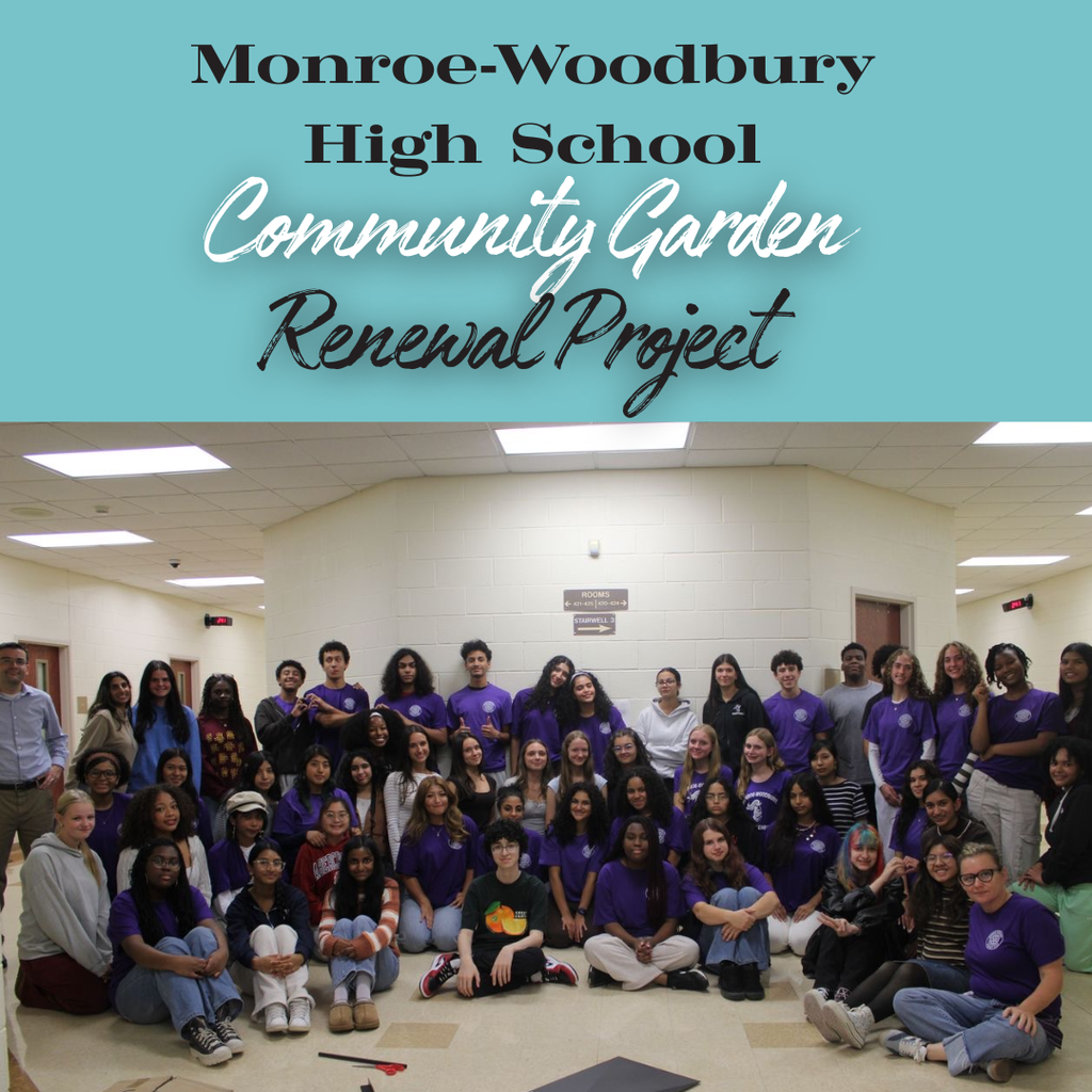 A group of people in purple shirts gathered in a room, smiling for a photo. Text above reads "Monroe-Woodbury High School Community Garden Renewal Project."