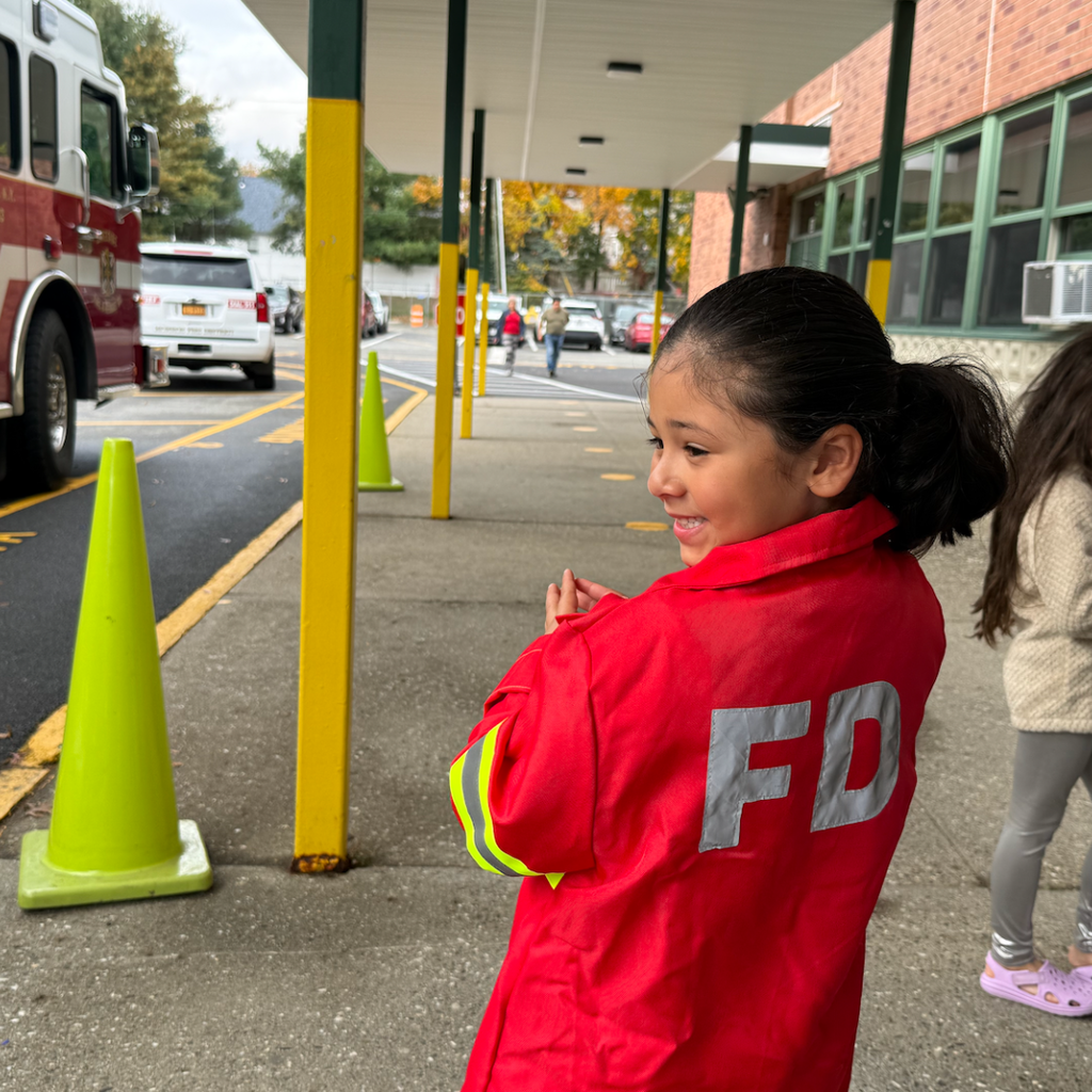 student wearing red jacket that says FD