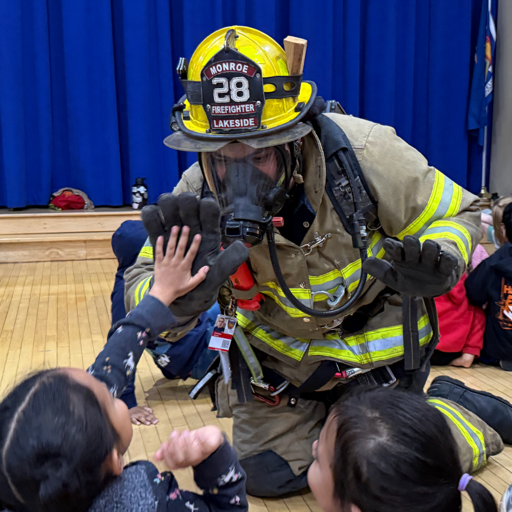 firefighter giving a student a high 5