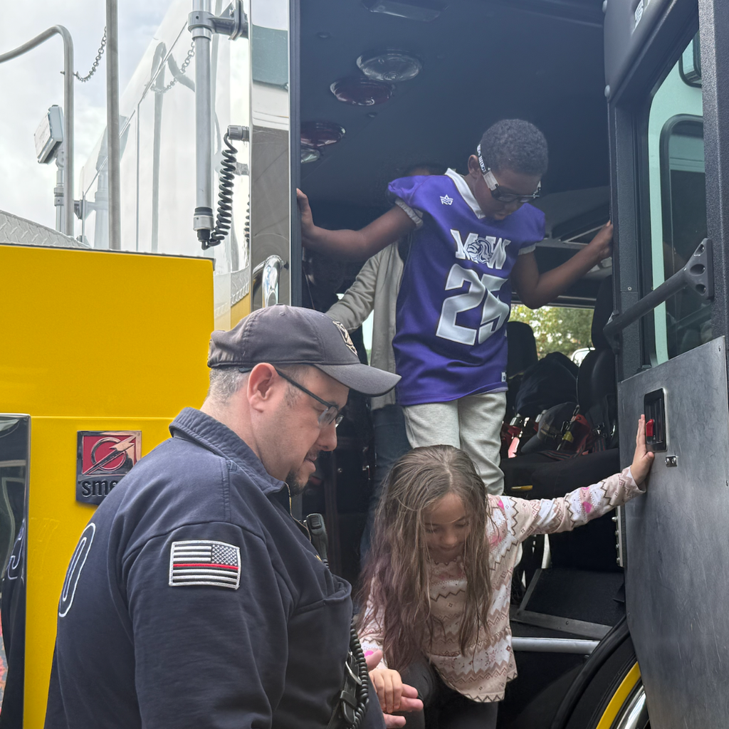 students climbing out of fire truck 