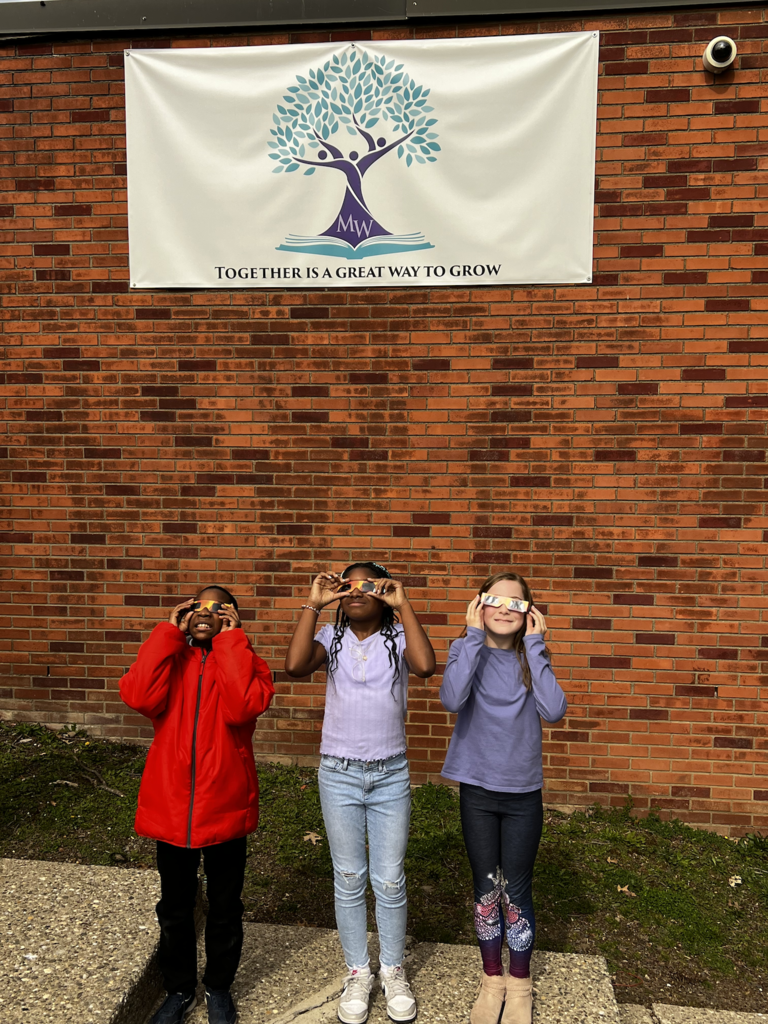students looking at eclipse