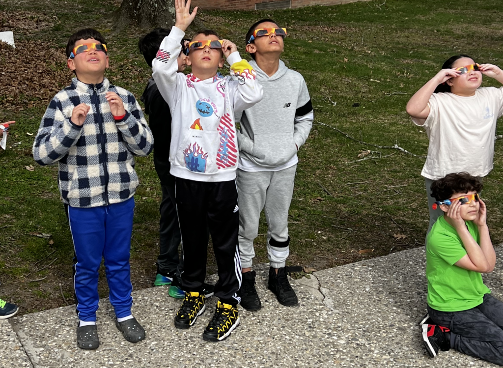 students looking at eclipse