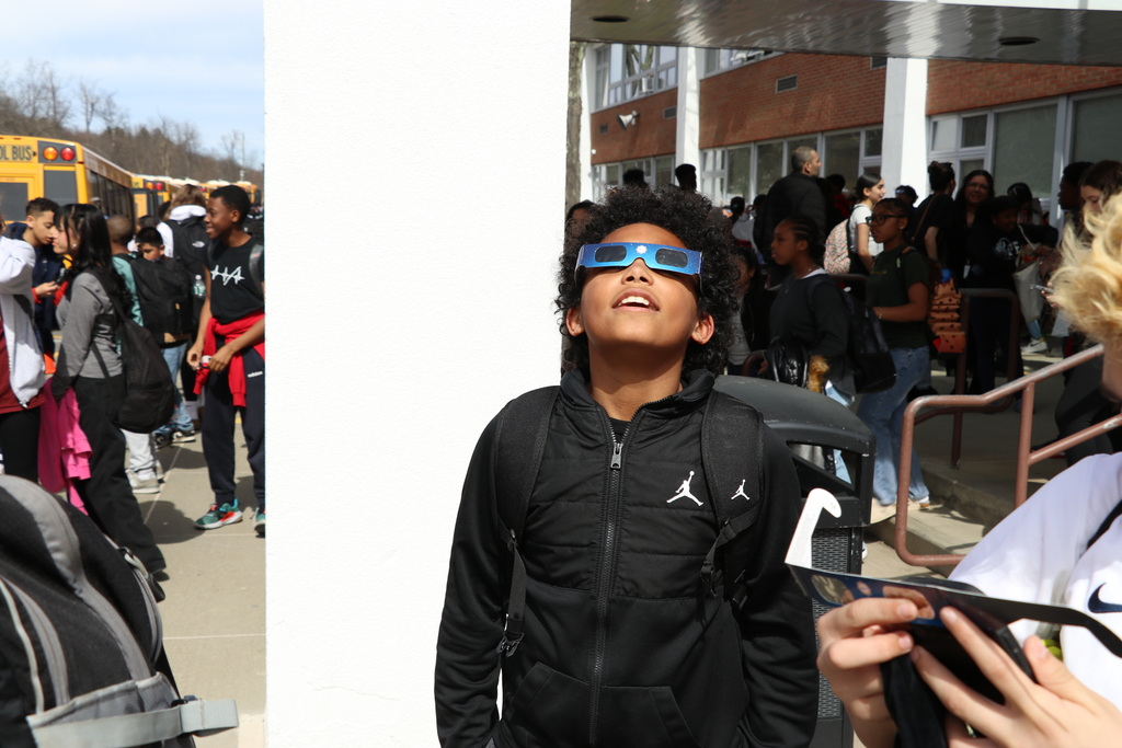 student looking at eclipse