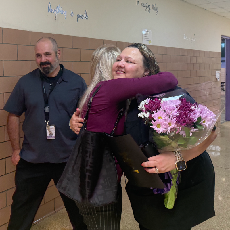 Cemile gets a hug from her coworker
