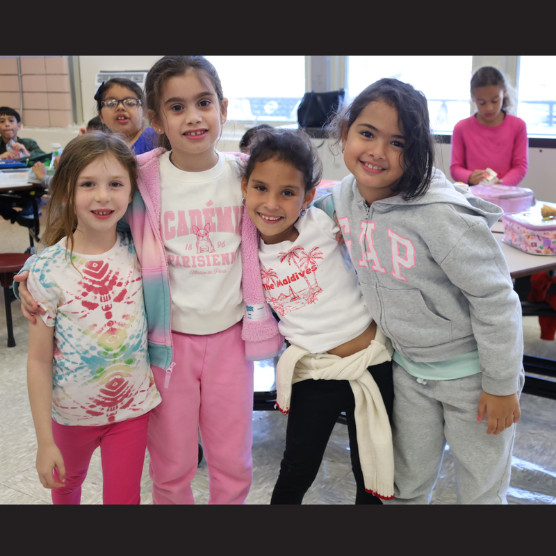 four girls standing together smiling