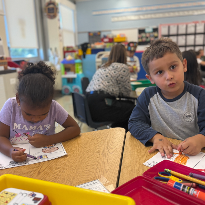 boy with blue and grey shirt and girl with purple shirt