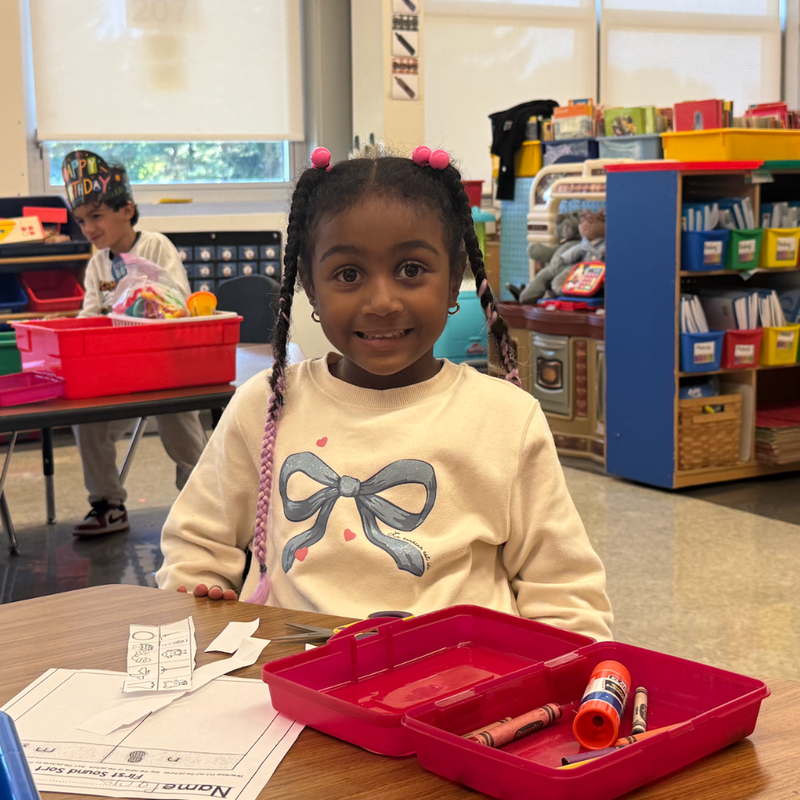 girl with pink bows smiling