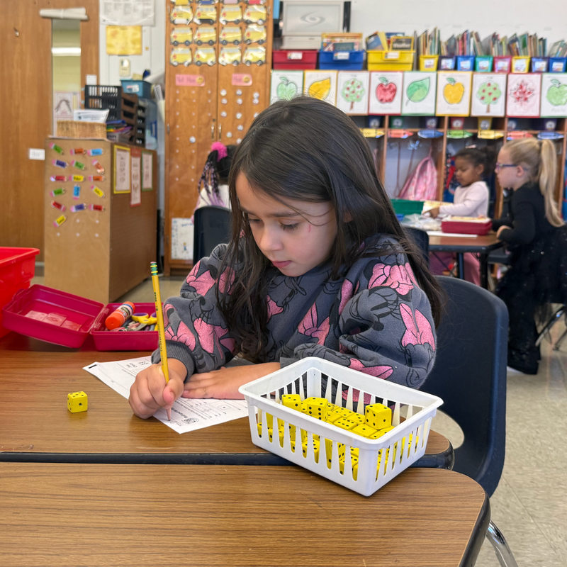 girl sitting with yellow blocks