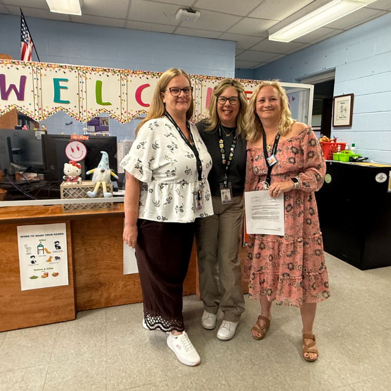 three women standing in a nurse's office