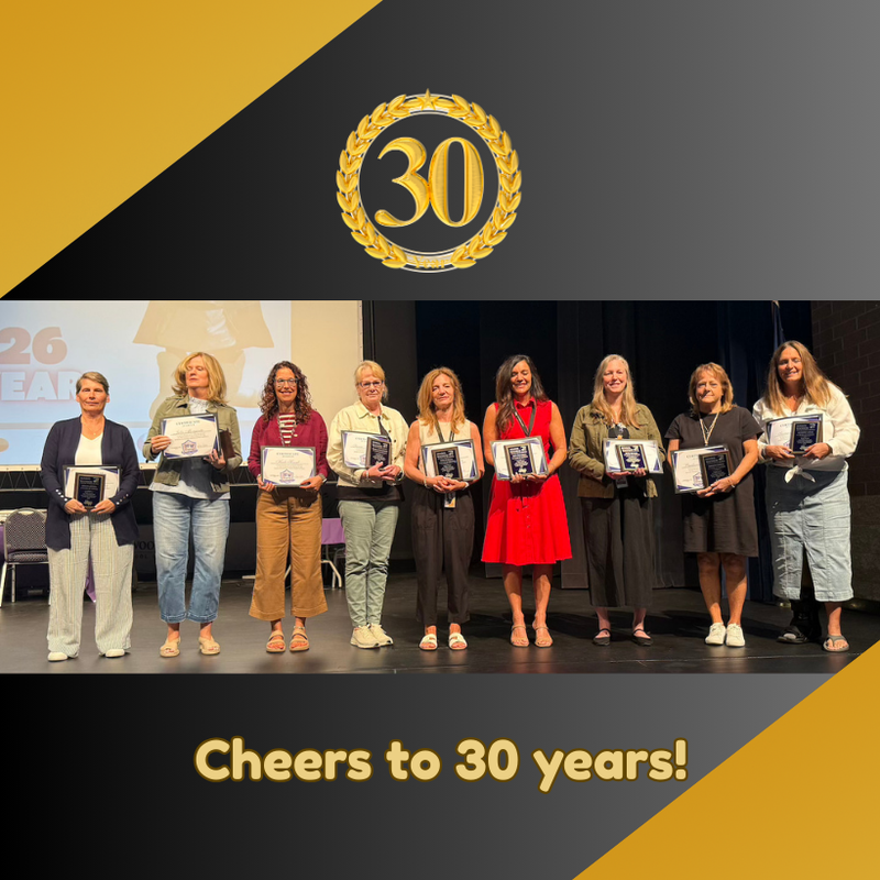 teachers standing on stage with awards