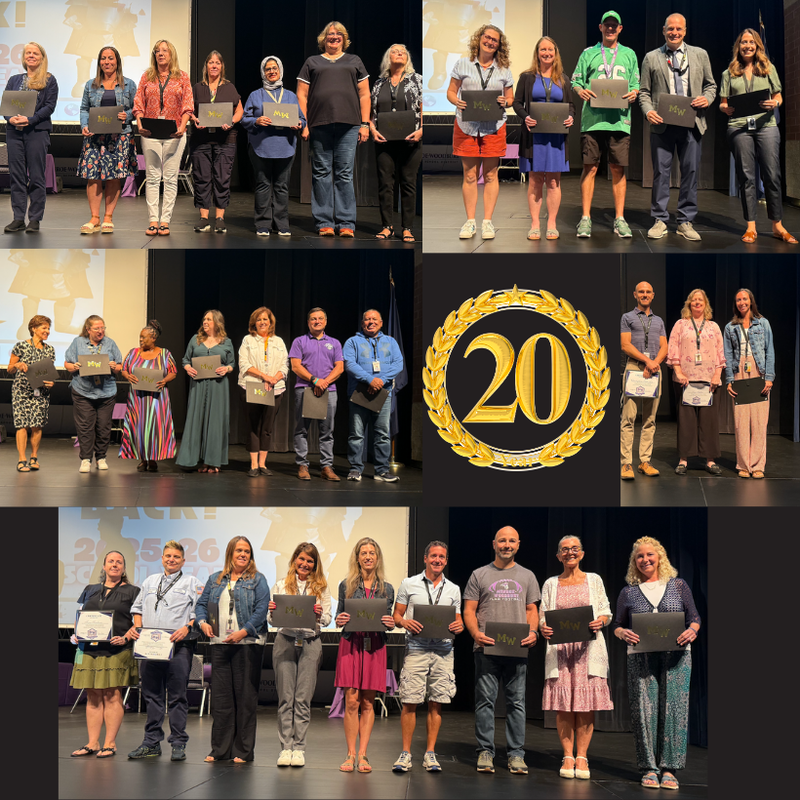 teachers standing on stage with awards